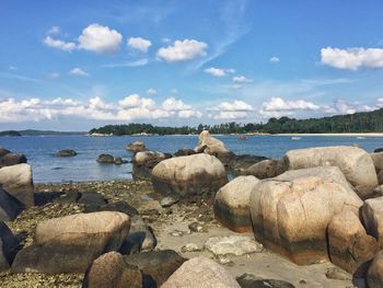 Rocks in sea against sky