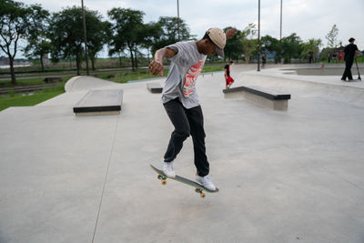 Full length of man skateboarding on skateboard