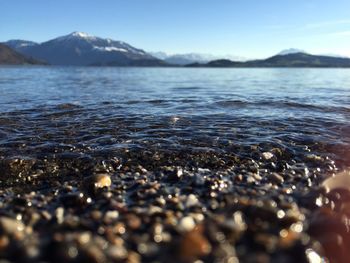 Scenic view of sea with mountain in background