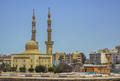 Buildings against clear blue sky