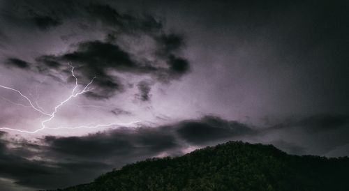 Low angle view of lightning against sky at night