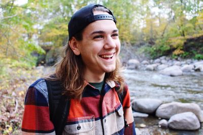 Portrait of smiling young woman in forest