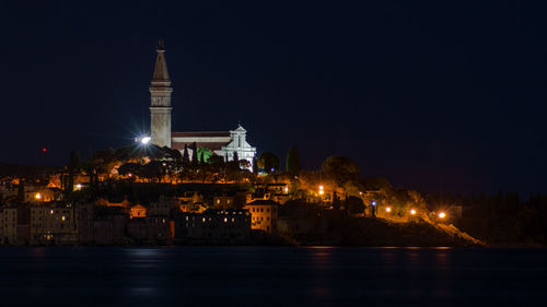 The city and the church of rovinj, captured over the bay at night