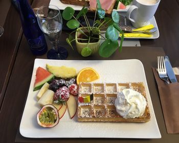 High angle view of dessert with fruits on table