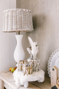 Close-up of white animal on table against wall at home