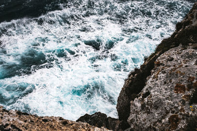 Sea waves splashing on rocks