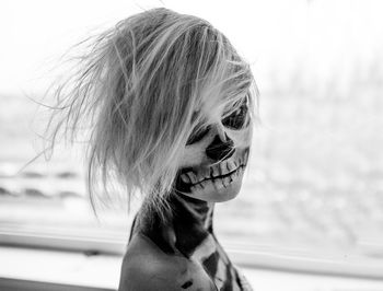 Close-up portrait of a girl in skeleton body paint