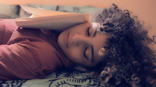 Young woman sleeping on bed at home