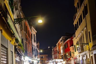 Low angle view of buildings against sky at night