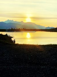 Scenic view of lake against sky during sunset