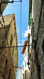 Low angle view of buildings against blue sky