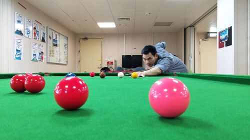 Man playing with ball and table at home
