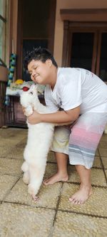 Portrait of boy playing with dog