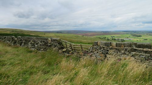 Scenic view of landscape against cloudy sky