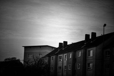 Exterior of buildings against sky at dusk