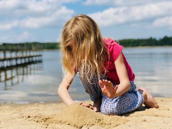 Full length of girl at beach against sky