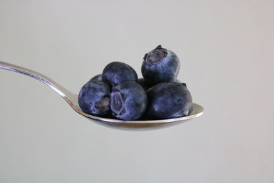 Close-up of fruits in bowl against white background