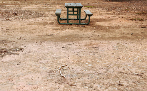 Empty picnic bench on dry field