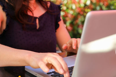 Midsection of woman using mobile phone