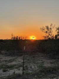 Scenic view of field against sky during sunset