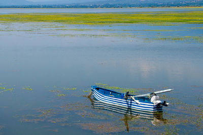 High angle view of fishing boat moored at lake