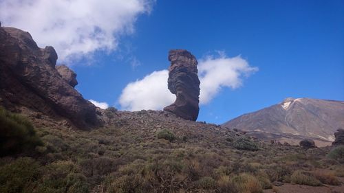 Panoramic view of volcanic landscape against blue sky