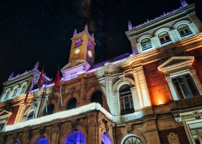 Low angle view of illuminated building against sky at night