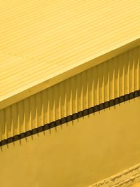 Full frame shot of yellow wall with reflection
