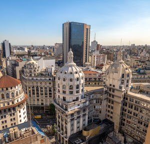 Buildings in city against clear sky