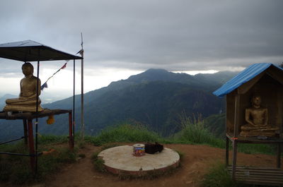 Built structure on land against mountains