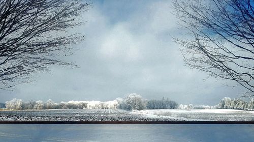 Scenic view of frozen lake against sky during winter