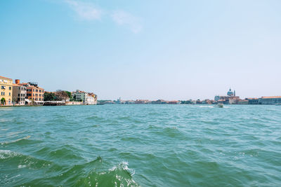 Scenic view of sea and buildings against sky