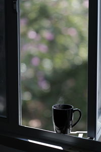 Close-up of coffee cup on window