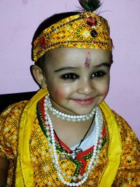 Smiling boy in krishna dress looking away