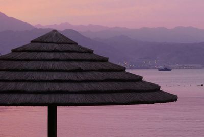 Scenic view of a canopy against the the red sea during sunset