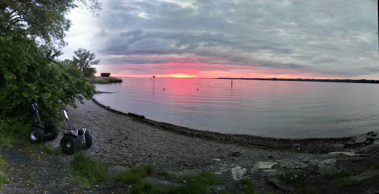 sky, water, tranquil scene, tranquility, sea, horizon over water, scenics, cloud - sky, beauty in nature, sunset, beach, nature, shore, cloudy, cloud, idyllic, tree, non-urban scene, calm, remote