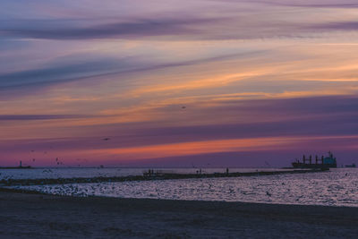 Scenic view of beach against sky during sunset