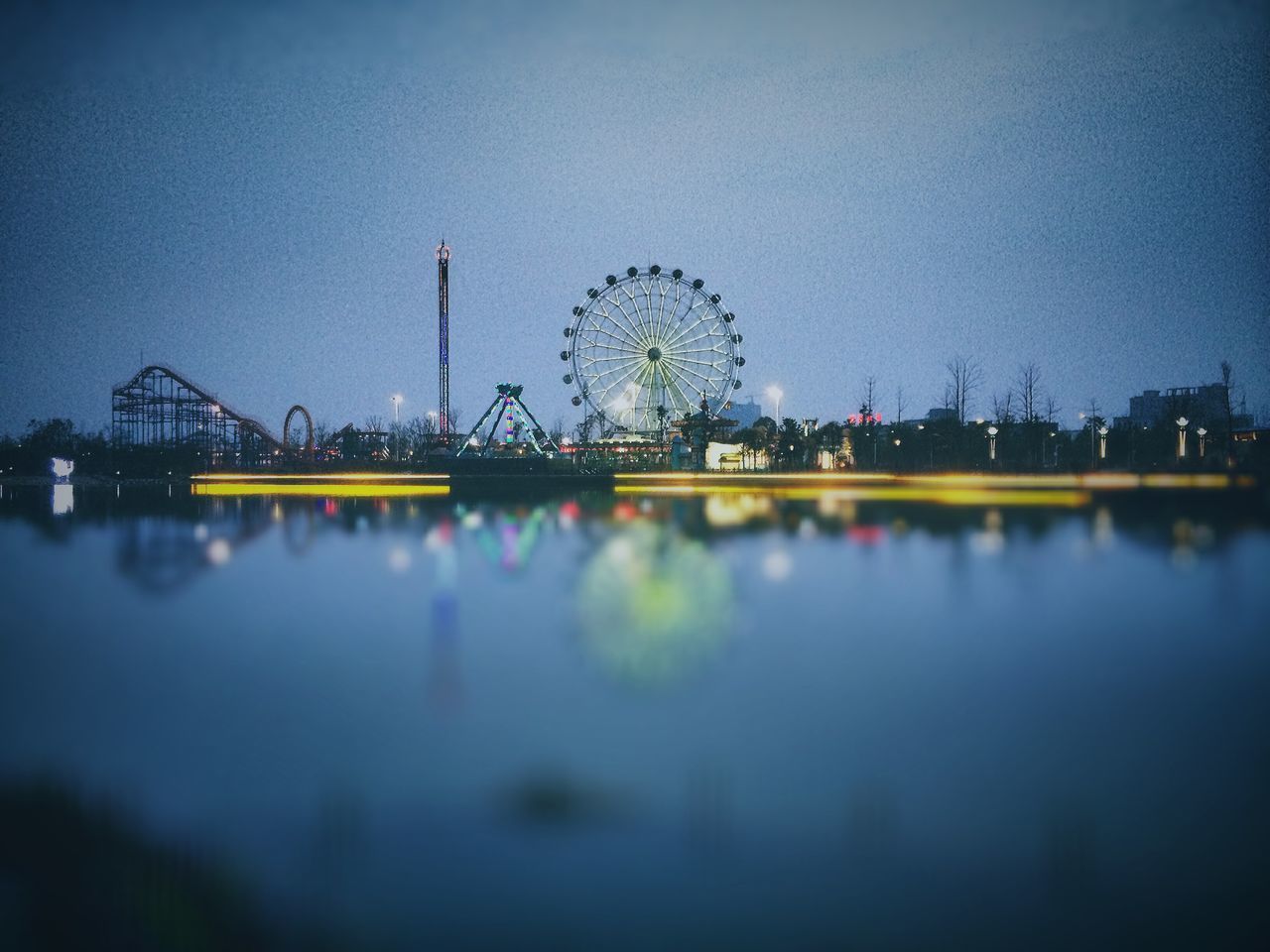 reflection, illuminated, water, night, sky, built structure, architecture, building exterior, waterfront, city, river, ferris wheel, dusk, clear sky, blue, lake, outdoors, copy space, standing water, no people