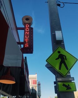 Low angle view of road signs against sky