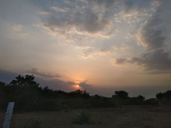 Scenic view of field against sky during sunset