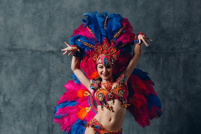 Low angle view of woman holding multi colored umbrella