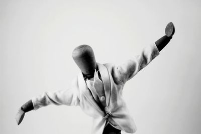 Wooden figurine with fabric against white background