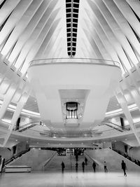 Low angle view of people walking in modern building