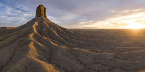 Erosion cuts deep lines in the earth surround the chimney rock m