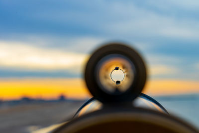 Close-up of illuminated airplane against sky during sunset