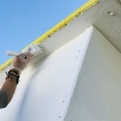 Low section of man painting a wall