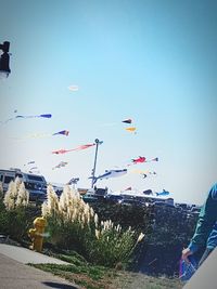 Low angle view of person paragliding against clear blue sky