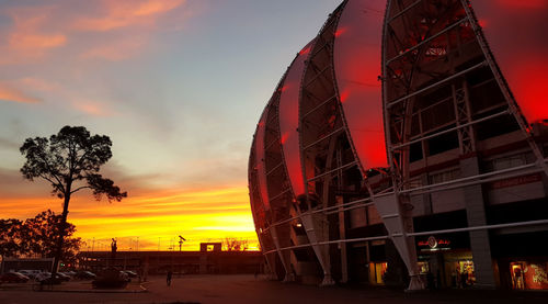 Silhouette of ferris wheel against sky at sunset