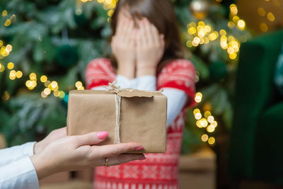 Hands of woman holding gift box