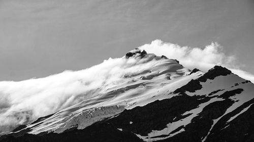 Low angle view of snowcapped mountain against sky